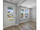 Bright, airy room with hardwood floors, with a door leading outside and two large windows at 515 Ivy Green Ln, Summerville, SC 29486