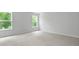 Well-lit bedroom with large windows offering serene outdoor views and plush carpet at 517 Yukon Ct, Summerville, SC 29485