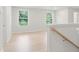 Upstairs hallway with natural lighting from windows and wood railing leading to rooms and living spaces at 754 Minton Rd, Charleston, SC 29414