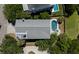 Aerial view of backyard pool with deck, lush trees, landscaped lawn, and view of the water at 764 Post Oak Dr, Mount Pleasant, SC 29464