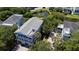 Aerial view of a stunning house with multiple decks and a gray roof, surrounded by lush landscaping and trees at 764 Post Oak Dr, Mount Pleasant, SC 29464