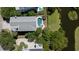 Aerial view of backyard pool and deck, surrounded by lush greenery, and a view of the water at 764 Post Oak Dr, Mount Pleasant, SC 29464