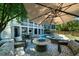 Stunning outdoor area with pool, spa, patio seating, and a fire pit for ultimate relaxation at 764 Post Oak Dr, Mount Pleasant, SC 29464