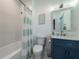 Bright and clean bathroom featuring a tub shower, toilet, and blue vanity with a white countertop at 764 Post Oak Dr, Mount Pleasant, SC 29464