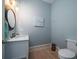Elegant powder room with marble countertop, modern fixtures, and charming coastal artwork at 764 Post Oak Dr, Mount Pleasant, SC 29464
