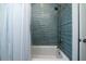 Bathroom boasts sleek blue subway tile surrounding the bathtub and showerhead at 764 Post Oak Dr, Mount Pleasant, SC 29464