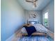 Cozy bedroom with a queen-sized bed, a ceiling fan, and a blue and white patterned rug at 764 Post Oak Dr, Mount Pleasant, SC 29464