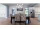 Bright dining room showcasing a rustic table, patterned chairs, and a glimpse of the modern kitchen at 764 Post Oak Dr, Mount Pleasant, SC 29464