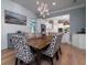 Elegant dining room features a modern chandelier and a view into the bright, white kitchen at 764 Post Oak Dr, Mount Pleasant, SC 29464