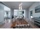 Elegant dining room with dark wood table, decorative chandelier, and gray walls at 764 Post Oak Dr, Mount Pleasant, SC 29464