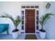 Inviting entryway featuring a wooden door, potted plants, and a stylish front porch at 764 Post Oak Dr, Mount Pleasant, SC 29464