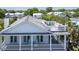Exterior view of a home featuring multiple decks, white railings, and a roof deck with outdoor seating at 764 Post Oak Dr, Mount Pleasant, SC 29464