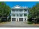 Charming two-story home with multiple balconies, lush landscaping, and a spacious driveway at 764 Post Oak Dr, Mount Pleasant, SC 29464