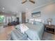 Spacious main bedroom with sitting area, light hardwood floors, and a stylish ceiling fan at 764 Post Oak Dr, Mount Pleasant, SC 29464