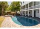 Inviting pool with a brick patio, hot tub, outdoor seating, and a partially covered outdoor living space at 764 Post Oak Dr, Mount Pleasant, SC 29464