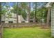 Spacious backyard featuring a well-maintained lawn and a classic wooden fence that adds privacy and charm to the property at 7886 Racquet Rd, North Charleston, SC 29418