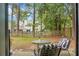 Inviting backyard with cozy seating area, lush trees, and a serene atmosphere, perfect for relaxation at 7886 Racquet Rd, North Charleston, SC 29418