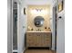 Bathroom vanity featuring a round mirror and a neutral color palette, complemented by a modern walk-in shower at 7886 Racquet Rd, North Charleston, SC 29418