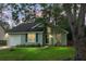 Charming single-Gathering home with a well-manicured lawn and attached garage nestled among mature trees at 7886 Racquet Rd, North Charleston, SC 29418