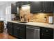 Well-equipped kitchen featuring modern stainless steel appliances, ample counter space and brick backsplash at 7886 Racquet Rd, North Charleston, SC 29418