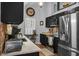 Modern kitchen featuring stainless steel appliances, sleek countertops, and dark cabinetry at 7886 Racquet Rd, North Charleston, SC 29418