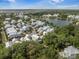 Scenic aerial shot of a lakeside community featuring charming homes, lush foliage, and tranquil water views at 7935 Flagship Ln, Johns Island, SC 29455