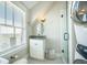 Bright bathroom featuring a vessel sink, shower with glass door, and a washer and dryer at 7935 Flagship Ln, Johns Island, SC 29455
