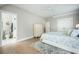 Bright bedroom with a connecting bathroom, neutral tones, and hardwood floors at 7935 Flagship Ln, Johns Island, SC 29455