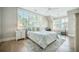 Well-lit bedroom with a comfortable bed, a ceiling fan, and multiple windows at 7935 Flagship Ln, Johns Island, SC 29455