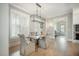 Cozy dining area featuring a rustic wooden table and a contemporary chandelier at 7935 Flagship Ln, Johns Island, SC 29455