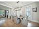 Inviting dining area with a wooden table, elegant chairs, and modern chandelier at 7935 Flagship Ln, Johns Island, SC 29455