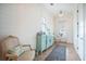Entryway featuring shiplap walls, a turquoise sideboard, and a vintage rug with classic furniture at 7935 Flagship Ln, Johns Island, SC 29455