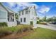 Stylish white home showcasing a two-car garage, manicured landscaping, and attractive curb appeal at 7935 Flagship Ln, Johns Island, SC 29455