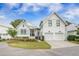 Charming white cottage-style home with a two-car garage, landscaped front yard, and inviting curb appeal at 7935 Flagship Ln, Johns Island, SC 29455