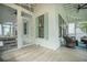 Spacious porch with chandelier, ceiling fans, and cozy seating areas at 7935 Flagship Ln, Johns Island, SC 29455