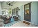 Inviting front porch with comfortable seating, ceiling fan, and stylish décor at 7935 Flagship Ln, Johns Island, SC 29455