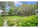 Lush green space with mature trees and manicured landscaping at 7935 Flagship Ln, Johns Island, SC 29455