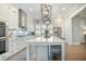 Well-lit kitchen with white cabinetry, stainless steel appliances, and center island with seating at 7935 Flagship Ln, Johns Island, SC 29455