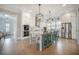 Modern kitchen features white cabinets, stainless steel appliances, and a large island with seating at 7935 Flagship Ln, Johns Island, SC 29455