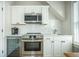 Modern kitchenette with stainless steel appliances, white cabinets, and quartz countertops at 7935 Flagship Ln, Johns Island, SC 29455