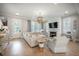 Bright living room with a large sectional sofa, fireplace, and hardwood floors at 7935 Flagship Ln, Johns Island, SC 29455