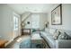 Living room features hardwood floors, a comfortable gray sectional, and ample natural light from windows at 7935 Flagship Ln, Johns Island, SC 29455