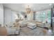 Spacious living room with a sectional sofa, area rug, and natural light at 7935 Flagship Ln, Johns Island, SC 29455