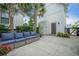 Back patio with ample seating, palm trees, and a stylish, paved area with access door at 7935 Flagship Ln, Johns Island, SC 29455