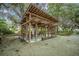 Inviting outdoor pavilion with wooden beams, ample seating, and a charming fireplace feature for gatherings at 7935 Flagship Ln, Johns Island, SC 29455