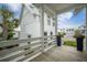 Exterior angle from porch featuring white columns and railings with a flower planter at 7935 Flagship Ln, Johns Island, SC 29455