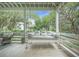 Cozy porch swing offers a relaxing spot to enjoy the peaceful surroundings at 7935 Flagship Ln, Johns Island, SC 29455