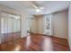Sunlit bedroom with hardwood floors, mirrored closet doors, and a ceiling fan at 7945 Parklane Ct # C, North Charleston, SC 29418