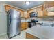 Traditional kitchen with stainless steel appliances, light wood cabinetry, and neutral countertops at 7945 Parklane Ct # C, North Charleston, SC 29418