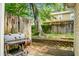 Fenced backyard featuring a brick patio, charcoal grill, and lush green foliage throughout the property at 7947 Vermont Rd, North Charleston, SC 29418